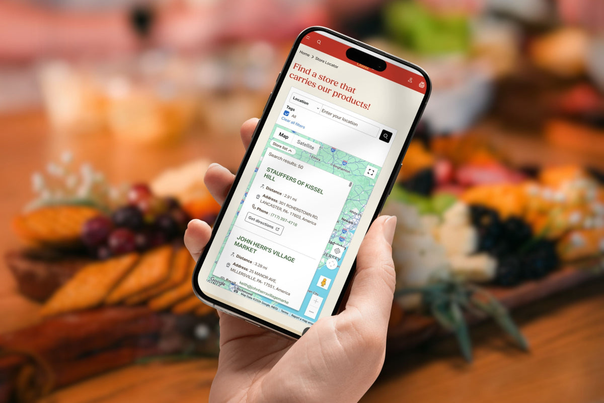 Hand holding mobile phone set to Dutch Country Cheese store locator